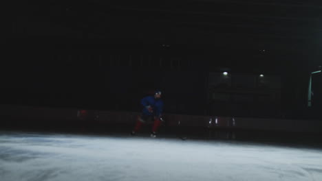 Two-professional-hockey-men-fighting-for-the-puck-on-the-ice-arena-using-force-techniques